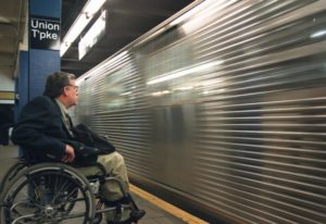 man in wheelchair on subway